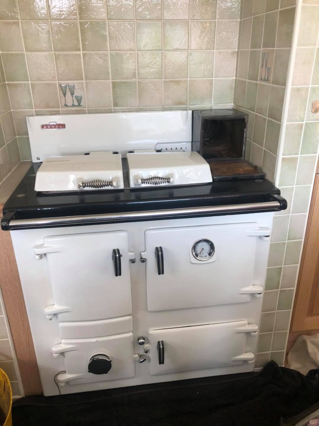 Cream range cooker set into a tiled kitchen wall