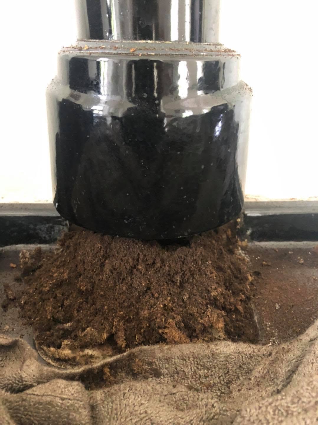 Soot and debris brought down onto a dust sheet beneath a stove flue pipe