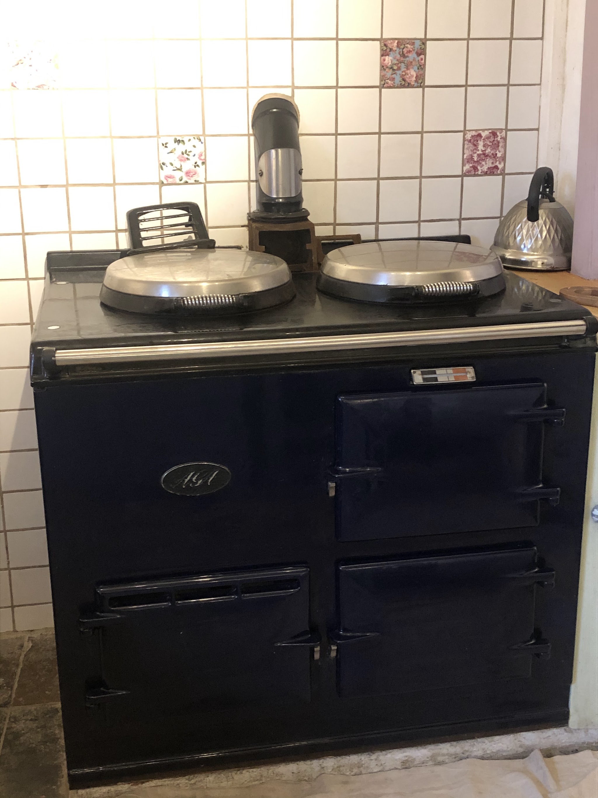 Dark blue range cooker in a tiled farmhouse kitchen